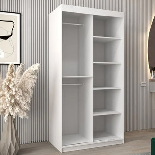 The CHOICEWARDROBE Danville White Mirrored Sliding Door Wardrobe features a modern compact design with two sections: left for hanging clothes, right with five shelves. It fits minimalist rooms and offers smooth glide storage.