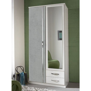 The CHOICEWARDROBE Dayton 2 Door 2 Drawer Mirrored Wardrobe in white & concrete grey features a full-length mirror, two drawers with silver handles, and a modern compact storage design. A green wall and chair are visible in the background.
