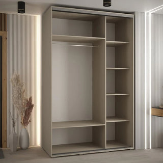 The CHOICEWARDROBE Delta 3 Door Sliding Wardrobe in Cashmere with black trim and shelving storage (150cm wide) stands against a light wall; dried plants and a wooden door are on the left, and a mirror is partly visible to the right.