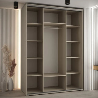 The CHOICEWARDROBE Delta Mirrored Sliding Door Wardrobe (3 Doors, 170cm) features a modern beige finish with black frame detailing and a central full-length mirror, perfect for stylish UK bedrooms with vertical wall paneling and decorative touches.