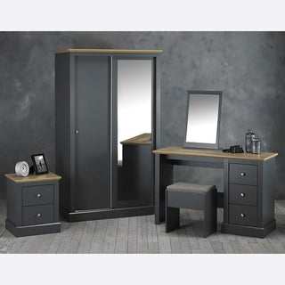 The CHOICEWARDROBE Devan 2 Door Sliding Wardrobe in charcoal grey with oak top and full-length mirror (113.8cm wide) pairs perfectly with a matching dressing table, mirror, stool, and a bedside table decorated with small accents.
