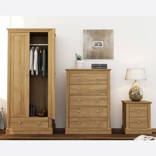 A CHOICEWARDROBE Devan 2 Door Wardrobe in oak finish (80cm wide) with drawer stands open to reveal hanging clothes, next to a matching chest of drawers with decor and a bedside table with lamp, all set against a white wall.