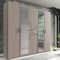 The CHOICEWARDROBE Docker 5 Door Mirrored Wardrobe in a 225cm matt grey finish, featuring drawers and ample hanging space, stands by a window and small plant against a gray wall. A light rug is on the floor.