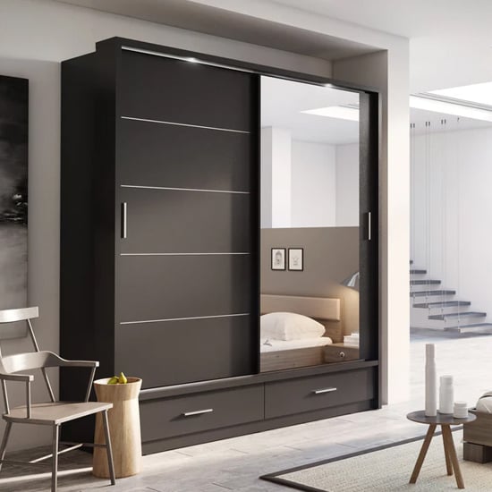 Matt black 2 door sliding wardrobe with mirror and drawers visible.