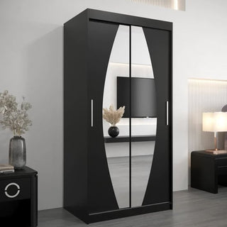 The CHOICEWARDROBE Eden 100cm Mirrored Sliding Door Wardrobe in black features modern storage with shelves, hanging rails, and smooth glide doors. Its mirrored panels and sleek design complement a contemporary bedroom setting.