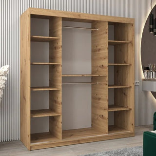 The CHOICEWARDROBE Eden 180cm Oak Mirrored Sliding Door Wardrobe features a contemporary curved mirror design, hanging rail, and storage shelves, and is styled with a natural oak finish in a modern room.