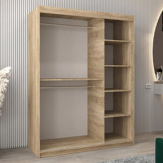 The CHOICEWARDROBE Eden 2 Door Mirrored Sliding Wardrobe (150cm Oak Finish) features a contemporary curved mirror design, shelving, and a hanging rail, providing stylish and practical bedroom storage with smooth sliding doors.