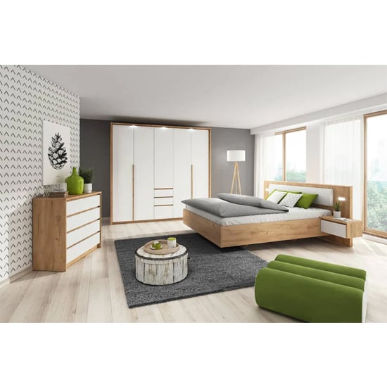 Elara 3-door hinged wardrobe in Golden Oak and White finish with integrated drawers.