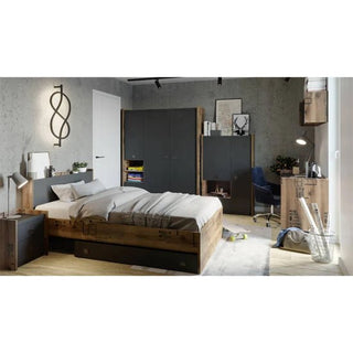 A modern bedroom features a wooden bed with gray bedding, the CHOICEWARDROBE Fairbourne 3 Door Wardrobe in raw steel and reclaimed wood effect, a desk with chair and lamp, bookshelves, wall art, decorative items, gray walls, and light wood flooring.