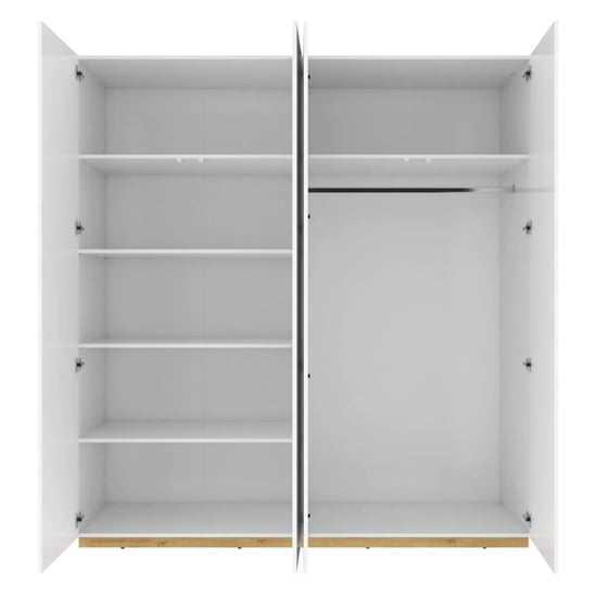 White high gloss 4 door wardrobe with open doors showing shelves and hanging rail