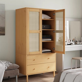 The CHOICEWARDROBE Fenland 2 Door Wooden Wardrobe features natural pine, rattan panel doors—one open to show shelves with clothes and boxes—and two drawers below. A vanity table and chair are visible in the background.