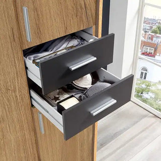 Close-up of graphite drawers on the Fenton oak wardrobe highlighting smooth glide design and contemporary craftsmanship.