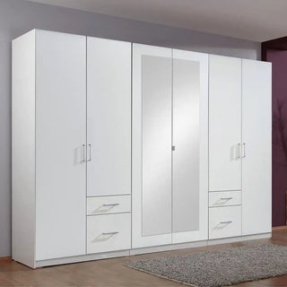 Large mirrored wardrobe styled in a modern UK bedroom, reflecting natural light to create a bright, spacious look.