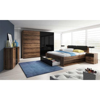 A modern bedroom featuring a rustic walnut bed with drawers, blue rug, side table, dresser by a blue accent wall, large windows, and the CHOICEWARDROBE Glens 2 Door Sliding Wardrobe in Rustic Walnut & Black Gloss with shelves and hanging rails.