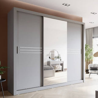 The CHOICEWARDROBE Hanover 3 Door Sliding Wardrobe with Mirror features a matt grey finish and horizontal decorative lines, offering modern bedroom storage (250cm) for UK homes. Shown in a bright, neutral contemporary setting.