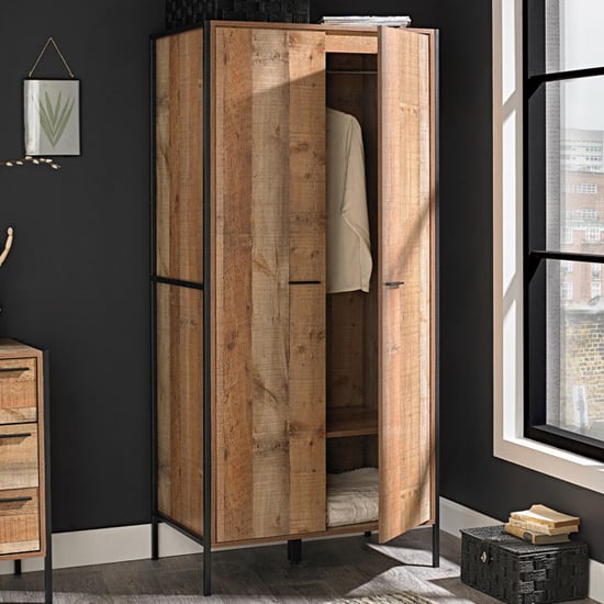 Haxtun 2-door distressed oak wooden wardrobe with industrial metal frame, doors open to reveal hanging rail and shelving.