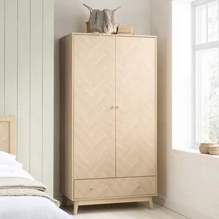 The CHOICEWARDROBE Helena 90cm 2 Door Wooden Wardrobe features a natural oak finish, chevron pattern front, bottom drawer, and Scandinavian tapered legs—perfect for stylish storage and enhancing any bedroom’s light decor.