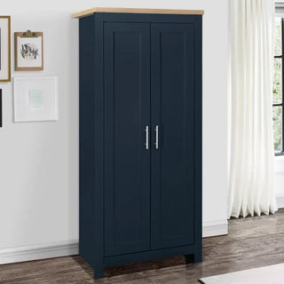 ChoiceWardrobe Highland 2 Door Wardrobe in Navy Blue with Oak Top styled in a bright modern bedroom