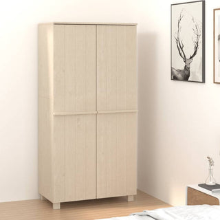 The CHOICEWARDROBE Hull Wardrobe, a 2-door wooden storage piece in light brown oak finish, stands in a corner with light walls and wood flooring. Nearby are framed art with a deer and a nightstand with vase for extra bedroom storage.