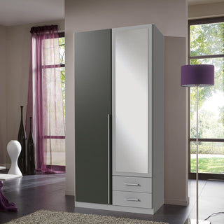 The CHOICEWARDROBE Husam 2 Door Wardrobe features a grey & white two-tone finish, one full-length mirrored door, two drawers below, and stands in a modern room with large windows, purple curtains, and a matching purple floor lamp.