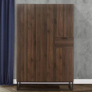 The CHOICEWARDROBE Huston 4 Door Wooden Wardrobe in walnut finish features an industrial metal frame and modern storage, shown against a gray wall with a dark blue curtain.