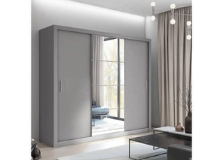 The CHOICEWARDROBE Inverto 3 Door Sliding Wardrobe (250cm, matt grey, central mirror, built-in shelves, double hanging rail) stands in a bright room with floor-to-ceiling curtains, a coffee table, and a stylish light fixture.