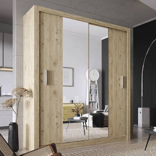 The CHOICEWARDROBE Ionia 180cm Rustic Oak Mirrored Sliding Door Wardrobe, featuring shelves and hanging rails, reflects a modern room with a white ladder shelf, clock, framed art, yellow dresser, dried plants, and minimal bedroom storage decor.