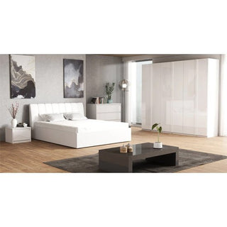 A modern bedroom with a white bed, two nightstands, a dresser, the CHOICEWARDROBE Iowa 6 Door High Gloss Wardrobe in white, a black coffee table on a gray rug, and two abstract paintings on neutral walls over wood flooring.