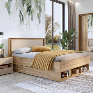 A modern bedroom with a CHOICEWARDROBE Irving Mirrored Sliding Door Wardrobe in Mauvella Oak, featuring drawers and shelving, a light gray mattress, white and gray bedding, mustard yellow blanket, nightstand, large windows, plant, and leafy wall mural.