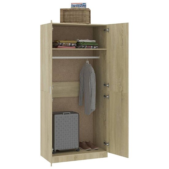 Sonoma Oak 2-door wardrobe with folded clothes, hanging shirt, suitcase, shoes, and wicker basket on top.