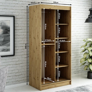 The CHOICEWARDROBE Laconia Mirrored Wardrobe—2 sliding doors, in black and oak, with shelves, hanging space, full-length mirror, and smooth glide tracks—is shown against a white brick wall. Dimensions: 200cm H x 100cm W x 62cm D.