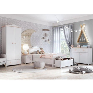 A children's bedroom with a white bed, stuffed animals, the CHOICEWARDROBE Lenoir Kids 2 Door Wardrobe (white finish), a pouf, dresser, string lights, teepee-shaped light decor, and geometric wallpaper featuring a moon accent.