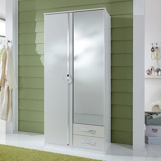 The CHOICEWARDROBE Liora 2 Door Wardrobe in high gloss white, with a single mirrored door, two bottom storage drawers, and silver handles, stands by a green paneled wall; a beige robe hangs left, accessories on hooks to the right.