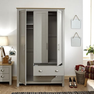 A CHOICEWARDROBE Loftus 3 Door Wooden Wardrobe in Grey & Oak stands open, showing hanging rails and shelves. Its classic panelled design features metal handles and lower drawers, perfect for stylish bedroom storage.