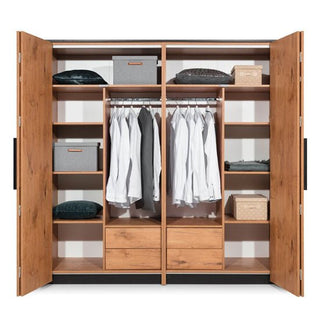 The CHOICEWARDROBE Logan 204cm 2 Door Folding Wardrobe in Lancelot Oak with black accents features shelves, a hanging rail for clothes, and bottom drawers—providing neat, organized bedroom storage for folded clothing, boxes, and shirts.