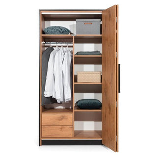 The CHOICEWARDROBE Logan Right-Side 1 Door Folding Wardrobe in Lancelot Oak & Black Frame shows hanging white shirts, folded bedding, two storage boxes, right-side shelves, and two bottom drawers with industrial modern style.