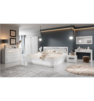 A modern bedroom with a white bed, nightstand, dresser, vanity, and the CHOICEWARDROBE Lyria 4 Door High Gloss Wardrobe in sleek white with drawers. Textured gray walls, pendant lights, and layered beige and gray rugs complement the glossy white floor.