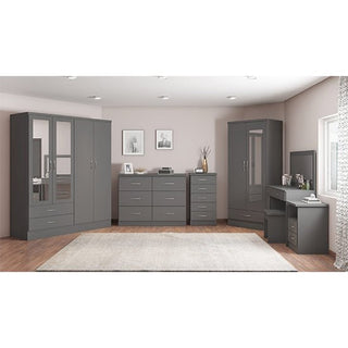 A bedroom with the CHOICEWARDROBE Mack 78cm 2 Door Mirrored Wooden Wardrobe in grey provides ample storage. Light walls, a beige rug over wood floors, and framed pictures above dressers complete the look.