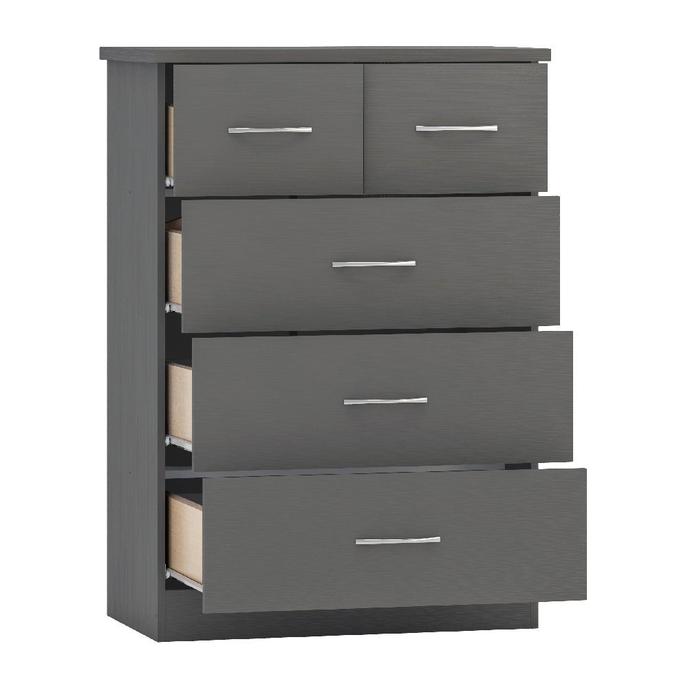 Grey wooden chest of drawers with five drawers and silver handles, some drawers partially open.