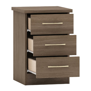 The CHOICEWARDROBE Mack Oak Wooden 4 Piece Bedroom Furniture Set features a modern chest of drawers in a rustic oak finish with sleek handles, beige drawer interiors, and is shown isolated on a white background.