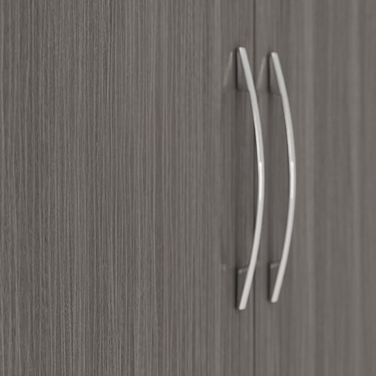 Close-up of two silver curved handles on grey woodgrain finish wardrobe doors