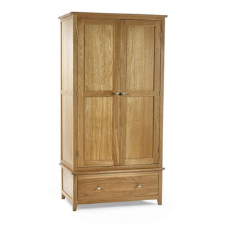The CHOICEWARDROBE Macon 2 Door Solid Oak Wardrobe in a natural finish features premium wooden construction, a classic paneled design with metal handles, a lower drawer, and short legs—offering timeless style and extra storage for your bedroom.