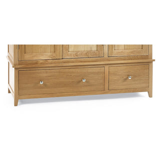 The CHOICEWARDROBE Macon 3 Door Solid Oak Wardrobe features a natural wood finish, classic panelled doors, and double drawer storage, providing practical bedroom storage that complements other oak furniture.