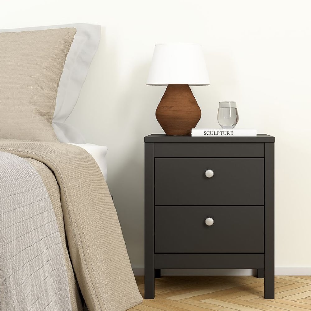 Black CHOICEWARDROBE Macron bedside table next to a bed. Modern bedroom furniture.