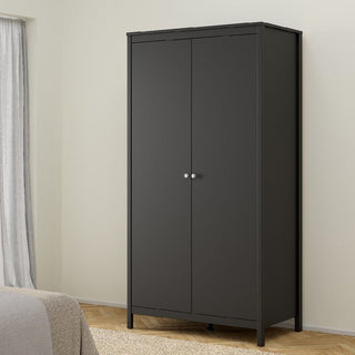 The CHOICEWARDROBE Macron 3 Piece Bedroom Furniture Set, featuring a black-finish 2 door wardrobe, chest of drawers, and bedside table, enhances the modern bedroom with its sleek look beside the window and beige-accented bed.