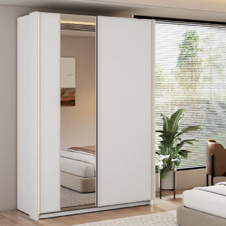 The CHOICEWARDROBE Madrid 2 Door Sliding Wardrobe (150cm, White Gloss) with full-length mirror, LED edge lighting, shelves, and hanging rail is shown in a bedroom with a bed, green plant, window blinds, and wall art.