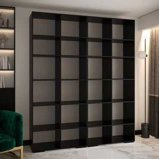 The CHOICEWARDROBE Madrid 4 Door Wooden Wardrobe, 200cm wide with a black fluted design and gold circular handles, stands against a light wall in a modern room, offering premium sliding storage perfect for luxury bedroom organization.