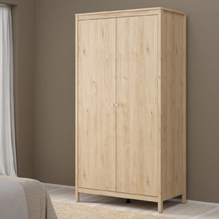 The CHOICEWARDROBE Malibu 3 Piece Bedroom Furniture Set features a modern oak-effect 2-door wardrobe with silver handles, ideal for stylish bedroom storage against a brown wall with light flooring and a nearby curtain.