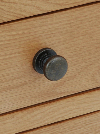 Close-up of the Marlborough wardrobe drawer handle showcasing antique-metal craftsmanship and oak grain texture.
