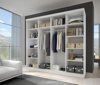 The CHOICEWARDROBE Mesa 2 Door Sliding Mirrored Wardrobe (233cm, black frame, oak panels), with full-length mirrors, hanging rail, and organised shelves, stands in a bright living area with large windows, white sofa, grey rug, and light wood flooring.